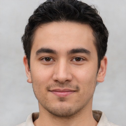 Joyful white young-adult male with short  black hair and brown eyes