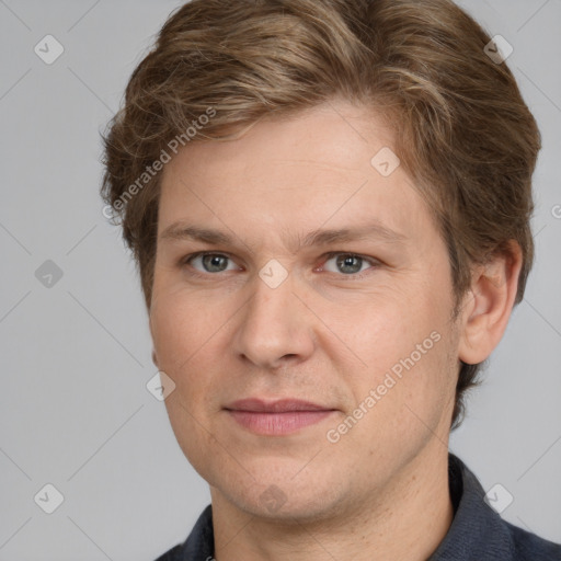 Joyful white adult male with short  brown hair and grey eyes