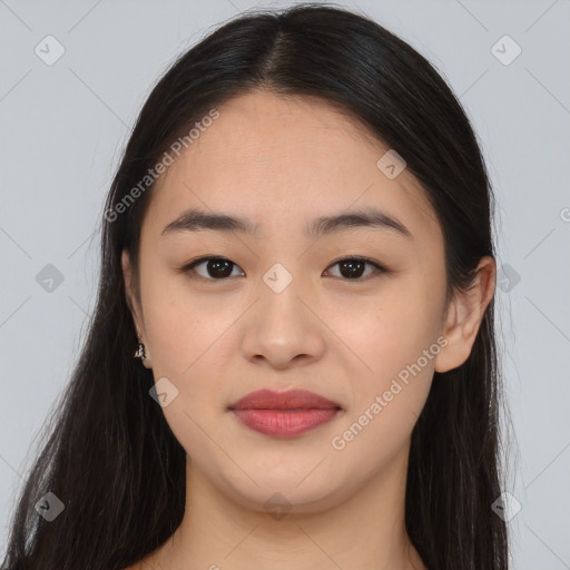 Joyful asian young-adult female with long  brown hair and brown eyes