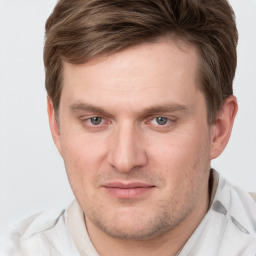 Joyful white young-adult male with short  brown hair and grey eyes