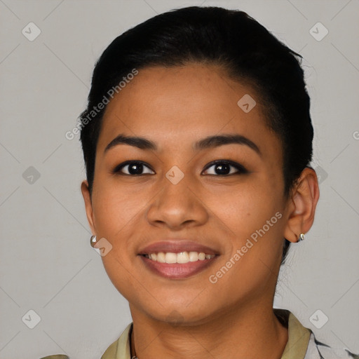 Joyful latino young-adult female with short  black hair and brown eyes