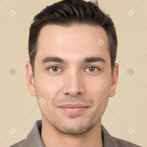 Joyful white young-adult male with short  black hair and brown eyes