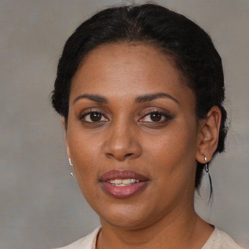 Joyful black young-adult female with medium  brown hair and brown eyes