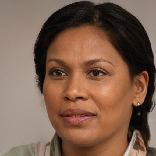 Joyful black adult female with medium  brown hair and brown eyes
