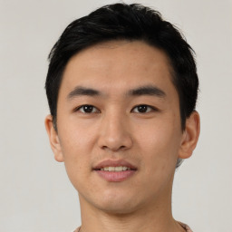 Joyful asian young-adult male with short  black hair and brown eyes