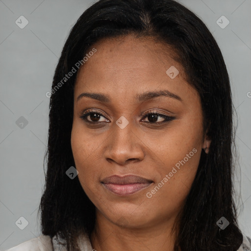 Joyful black adult female with long  brown hair and brown eyes