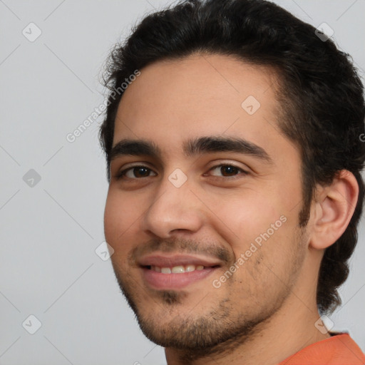 Joyful white young-adult male with short  black hair and brown eyes