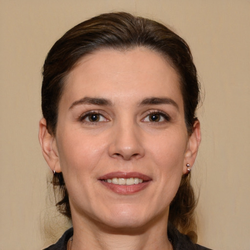 Joyful white young-adult female with medium  brown hair and brown eyes