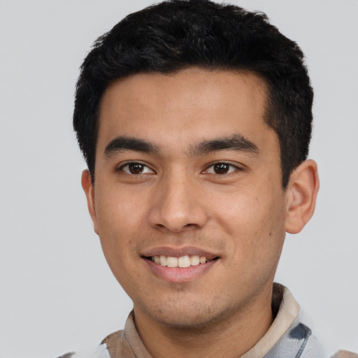 Joyful latino young-adult male with short  black hair and brown eyes