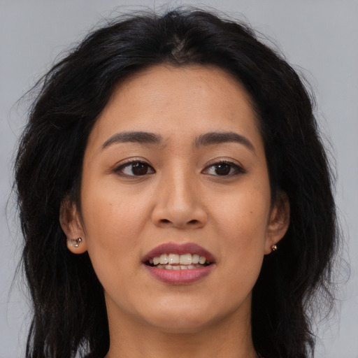 Joyful asian young-adult female with long  brown hair and brown eyes