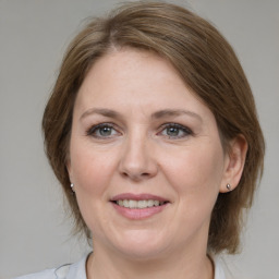 Joyful white adult female with medium  brown hair and grey eyes