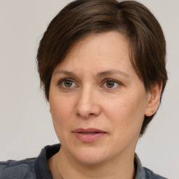 Joyful white adult female with medium  brown hair and brown eyes