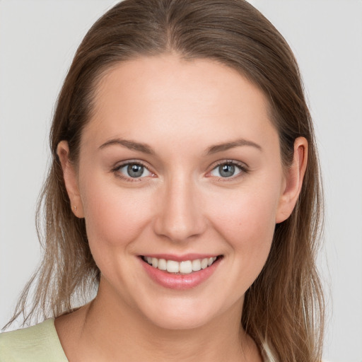 Joyful white young-adult female with long  brown hair and grey eyes