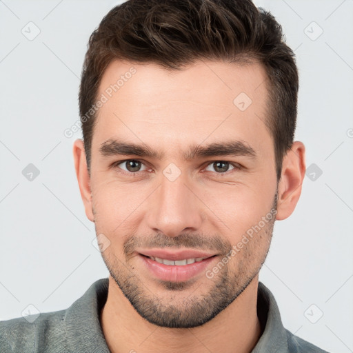 Joyful white young-adult male with short  brown hair and brown eyes