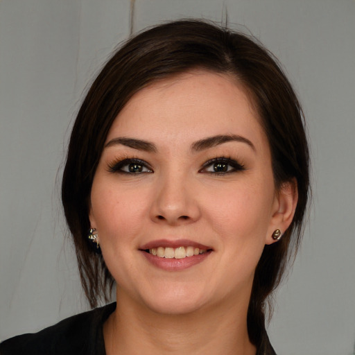 Joyful white young-adult female with medium  brown hair and brown eyes