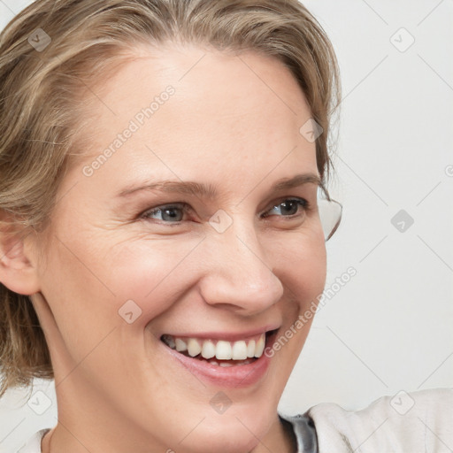 Joyful white young-adult female with medium  brown hair and blue eyes