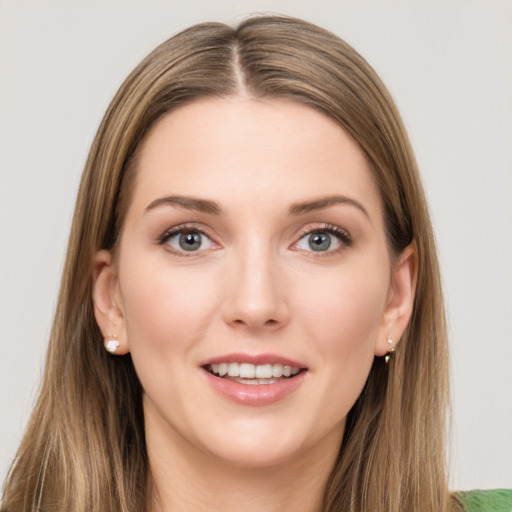 Joyful white young-adult female with long  brown hair and green eyes