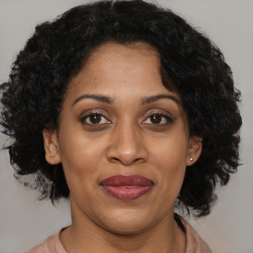 Joyful black adult female with medium  black hair and brown eyes