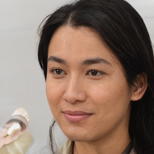 Joyful asian adult female with medium  brown hair and brown eyes