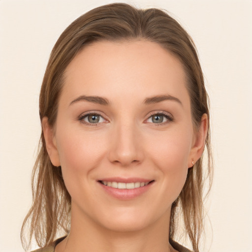 Joyful white young-adult female with long  brown hair and grey eyes