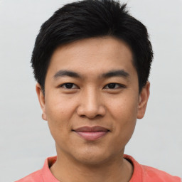 Joyful asian young-adult male with short  black hair and brown eyes