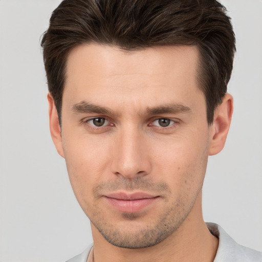 Joyful white young-adult male with short  brown hair and brown eyes