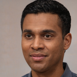 Joyful latino young-adult male with short  black hair and brown eyes