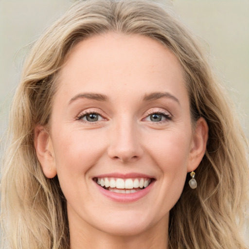 Joyful white young-adult female with long  brown hair and blue eyes