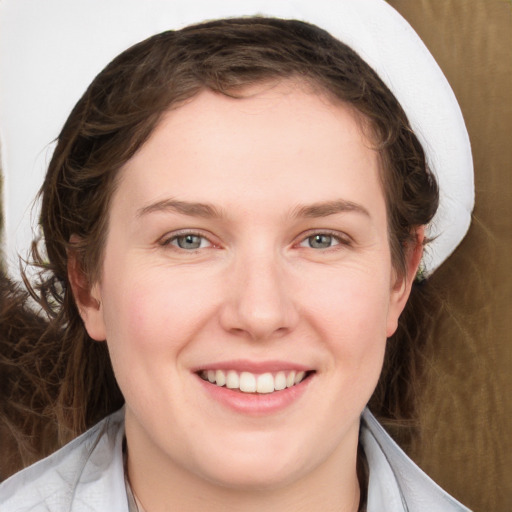 Joyful white young-adult female with long  brown hair and blue eyes