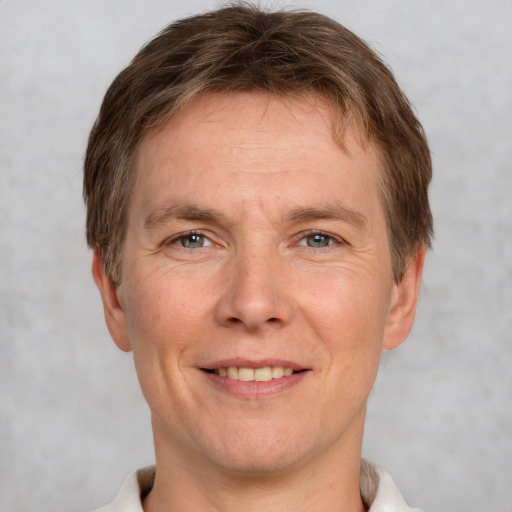 Joyful white adult male with short  brown hair and grey eyes