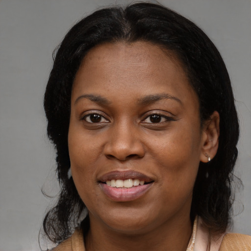 Joyful black young-adult female with medium  brown hair and brown eyes