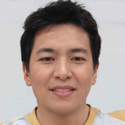 Joyful asian young-adult male with short  brown hair and brown eyes