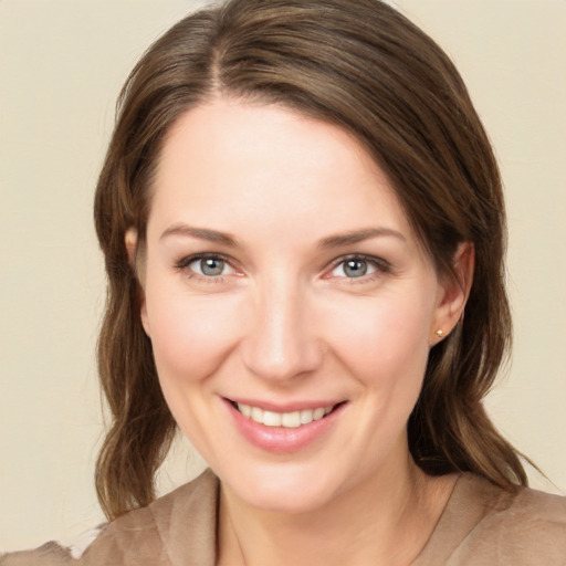 Joyful white young-adult female with medium  brown hair and green eyes