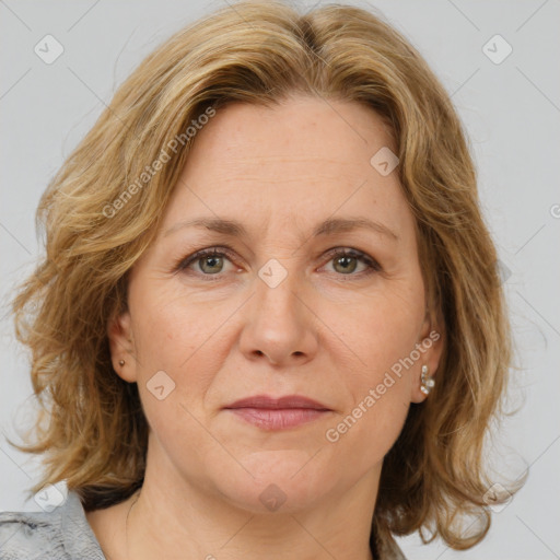 Joyful white adult female with medium  brown hair and blue eyes