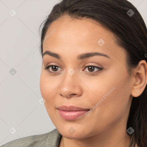 Joyful latino young-adult female with long  brown hair and brown eyes