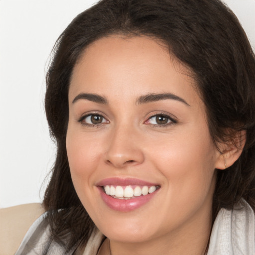 Joyful white young-adult female with long  brown hair and brown eyes