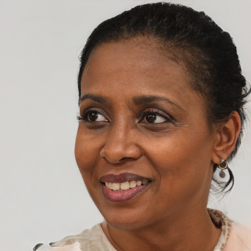Joyful black adult female with short  brown hair and brown eyes
