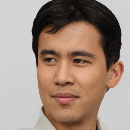 Joyful asian young-adult male with short  brown hair and brown eyes