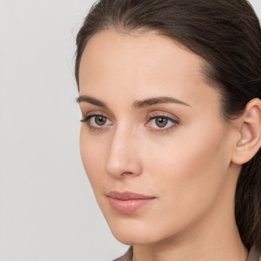 Neutral white young-adult female with long  brown hair and brown eyes