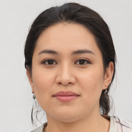 Joyful latino young-adult female with medium  brown hair and brown eyes