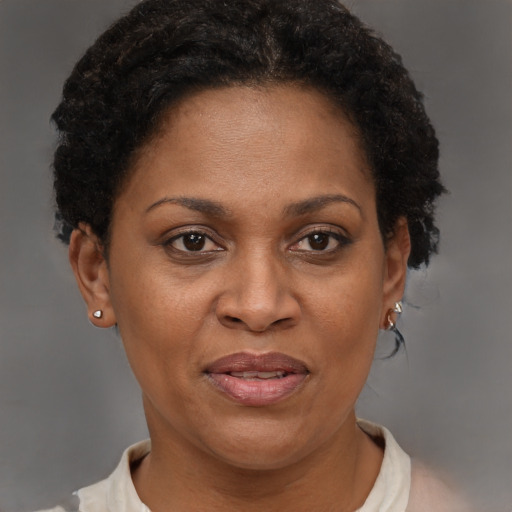 Joyful black adult female with short  brown hair and brown eyes