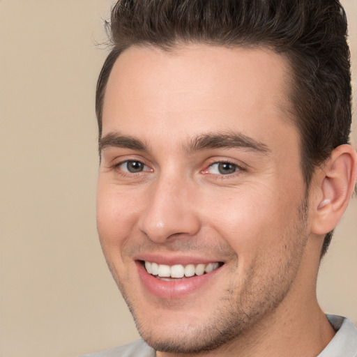 Joyful white young-adult male with short  brown hair and brown eyes