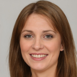 Joyful white young-adult female with long  brown hair and brown eyes