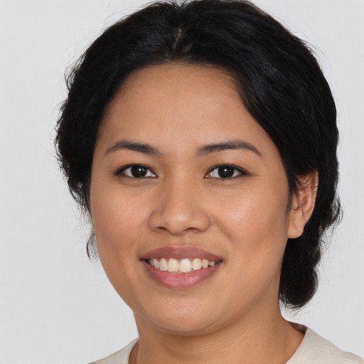 Joyful latino young-adult female with medium  black hair and brown eyes