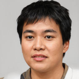 Joyful asian young-adult male with short  black hair and brown eyes
