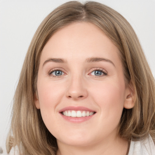 Joyful white young-adult female with long  brown hair and grey eyes