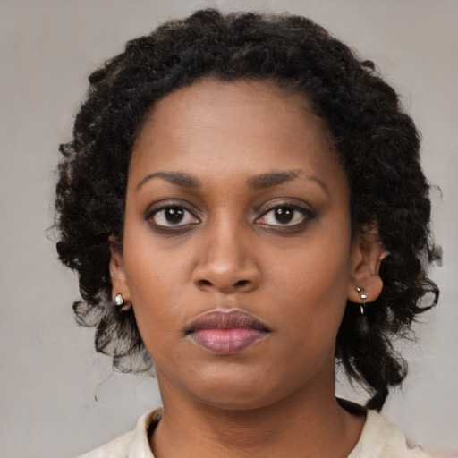 Neutral black young-adult female with medium  brown hair and brown eyes