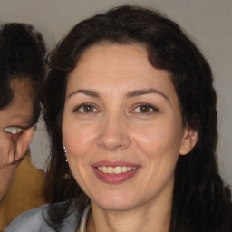 Joyful white adult female with long  brown hair and brown eyes