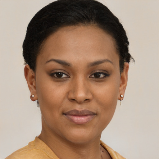 Joyful black young-adult female with short  brown hair and brown eyes