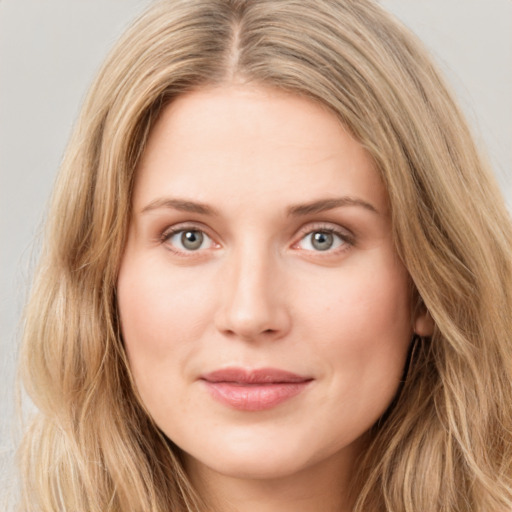 Joyful white young-adult female with long  brown hair and blue eyes